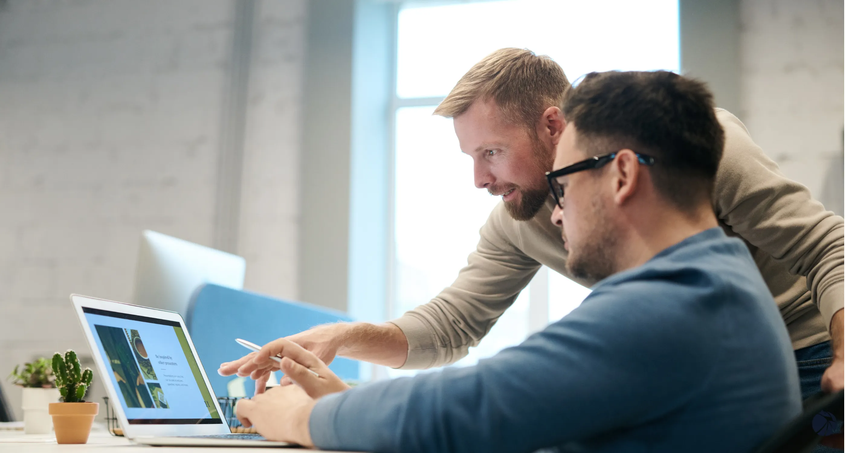 Two MSP professionals collaborating over a laptop in a working session.